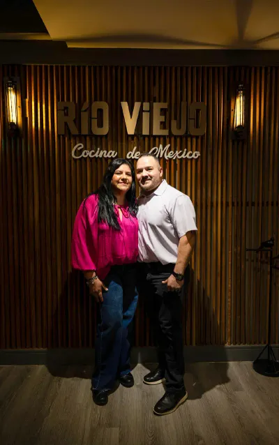 Guests at the Rio Viejo Cocina de Mexico sign