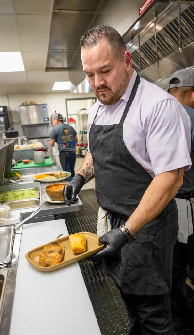 Chef Jaime Avila plating a dish in the Rio Viejo kitchen